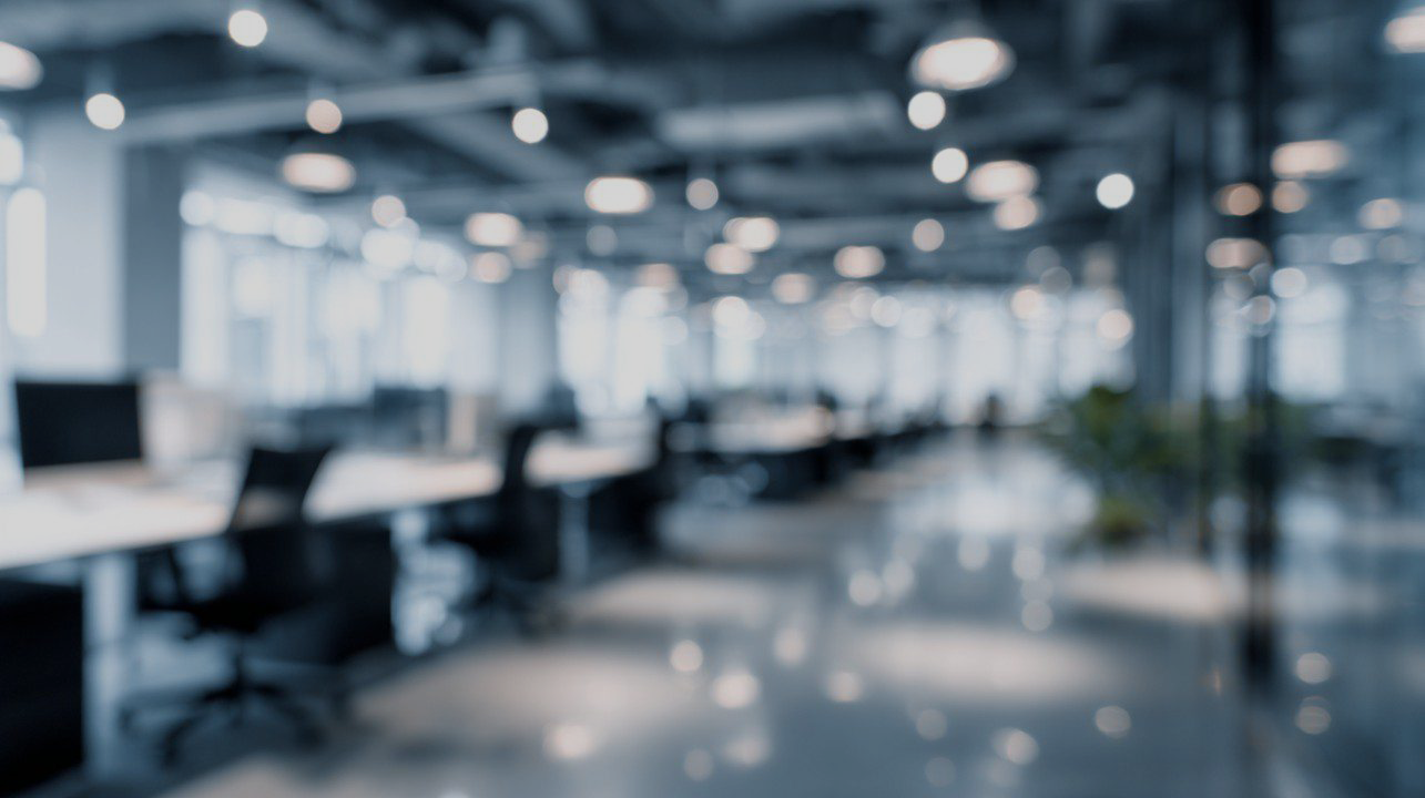 Blurred image of Wredd office workspace with modern tech and creative studio setup